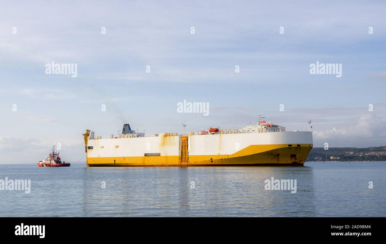 Container ship tossed by tossing boat Stock Photo