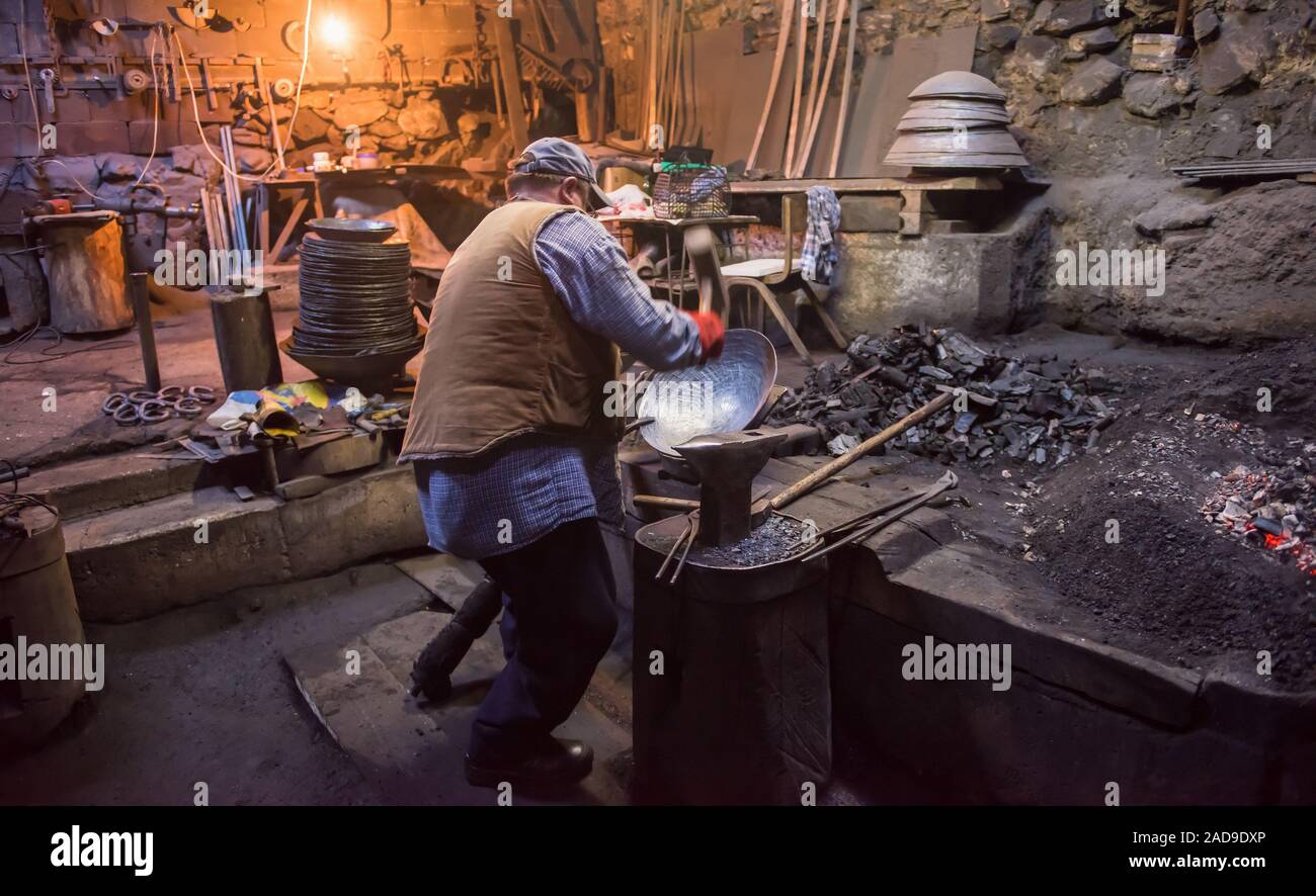 traditional blacksmith manually forging the molten metal Stock Photo ...