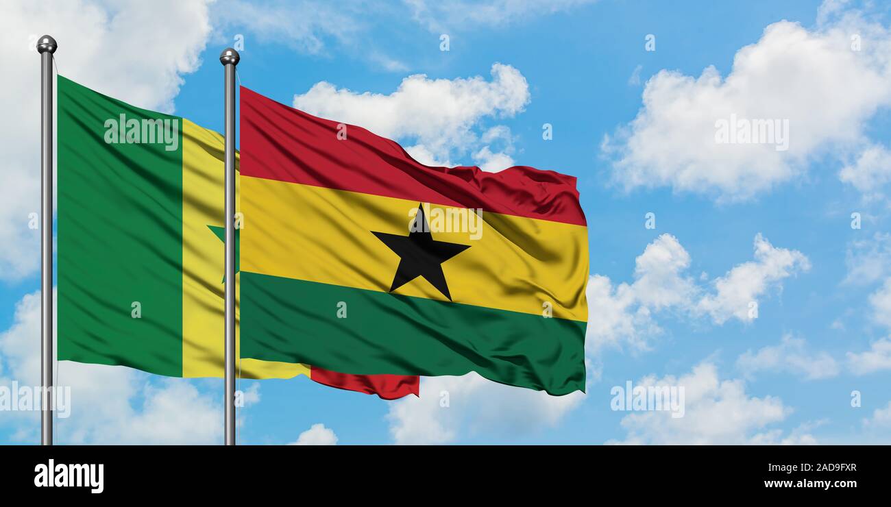 Senegal and Ghana flag waving in the wind against white cloudy blue sky together. Diplomacy concept, international relations. Stock Photo