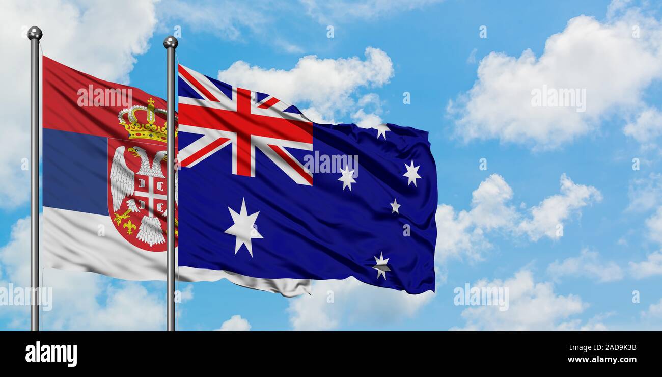 Serbia and Australia flag waving in the wind against white cloudy blue
