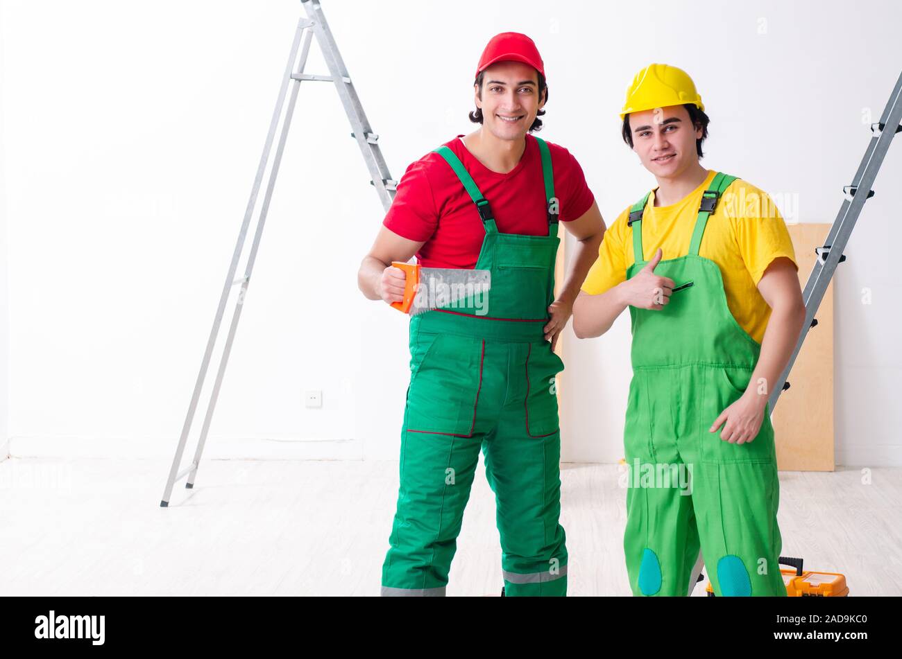 Two workers contractors working indoors Stock Photo