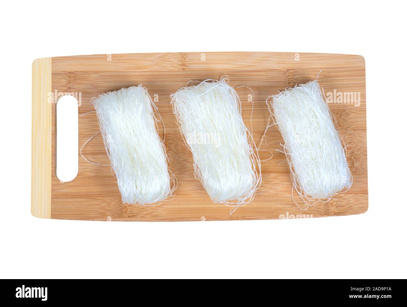 Dry bean noodles on a cutting board isolated on white. Stock Photo