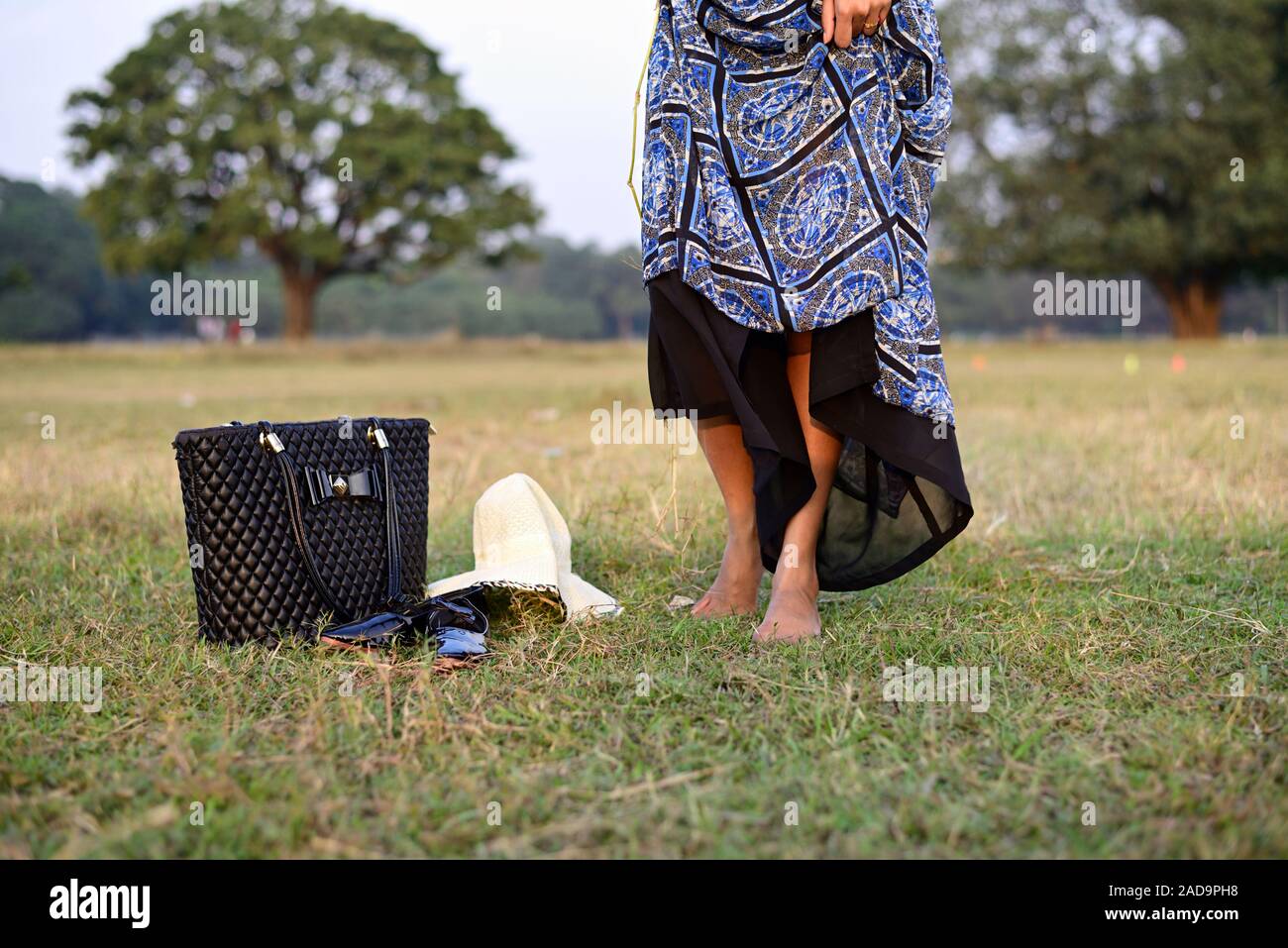 Woman walking barefoot on green grass Stock Photo - Alamy