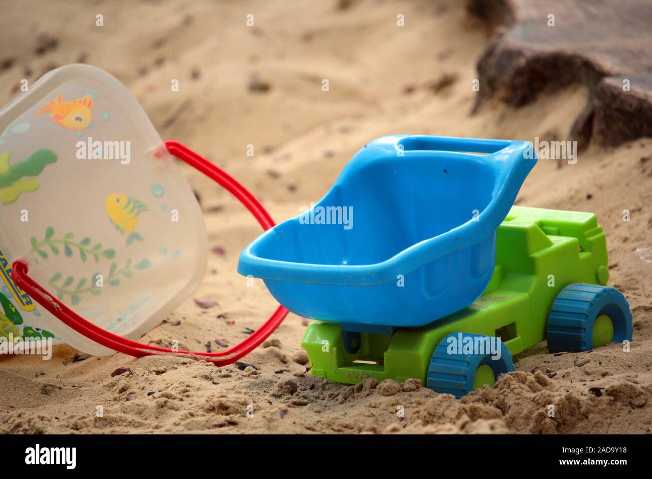 Sandpit with plastic toys Stock Photo