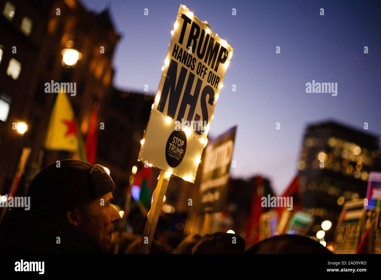 London, UK. 03rd Dec, 2019. An activist carries a placard opposing any post-Brexit US market access to Britain's National Health Service (NHS) during the demonstration.President Trump arrived in the UK on a three-day visit last night, chiefly to attend the NATO summit in Watford. Activists protest against Trump's visit in Trafalgar Square. Credit: SOPA Images Limited/Alamy Live News Stock Photo