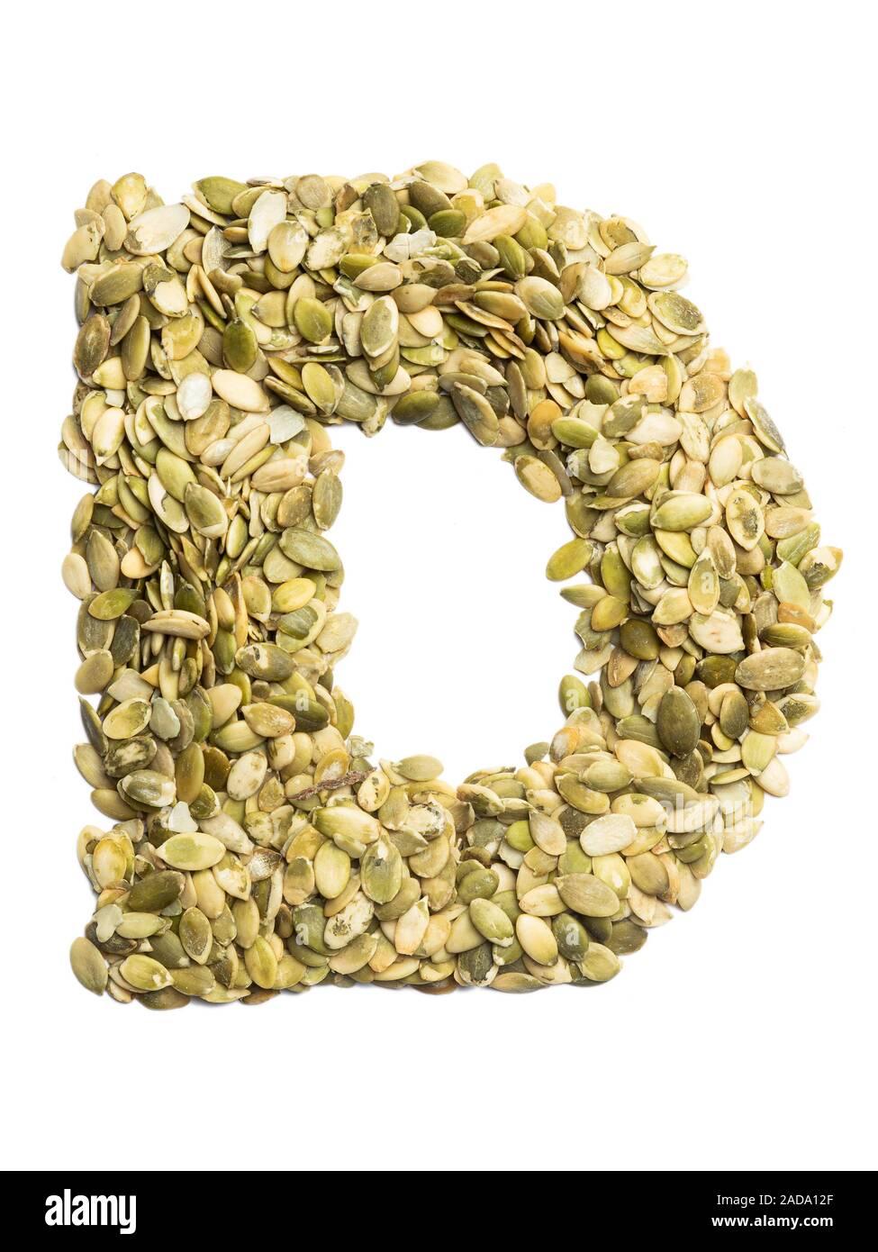 Letter D of the English alphabet from pumpkin seeds on a white isolated ...