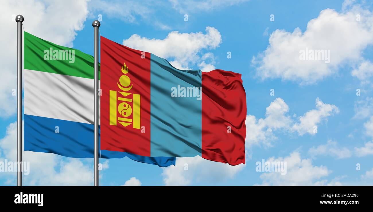 Sierra Leone and Mongolia flag waving in the wind against white cloudy blue sky together. Diplomacy concept, international relations. Stock Photo