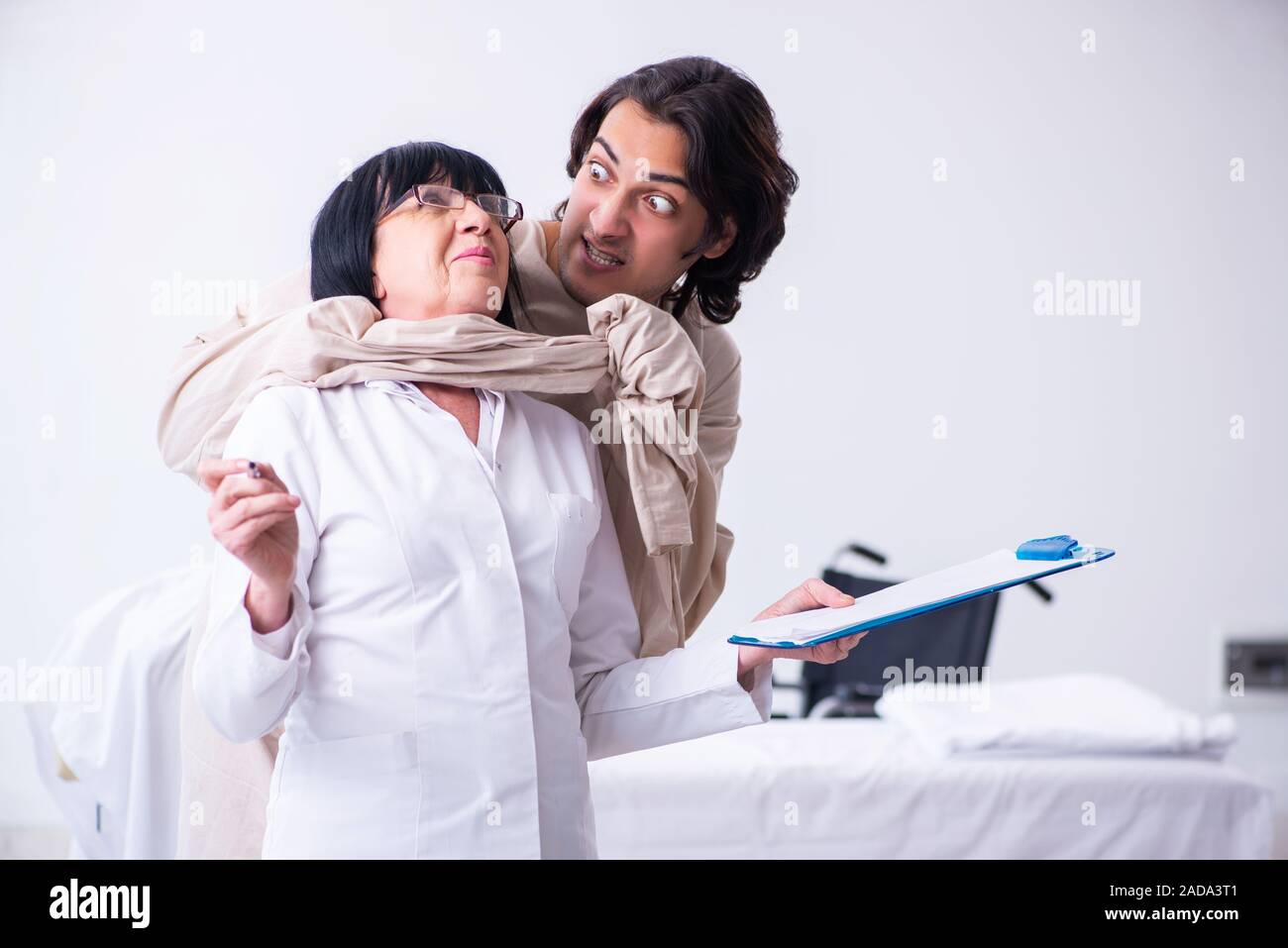 Old female psychiatrist visiting young male patient Stock Photo Alamy