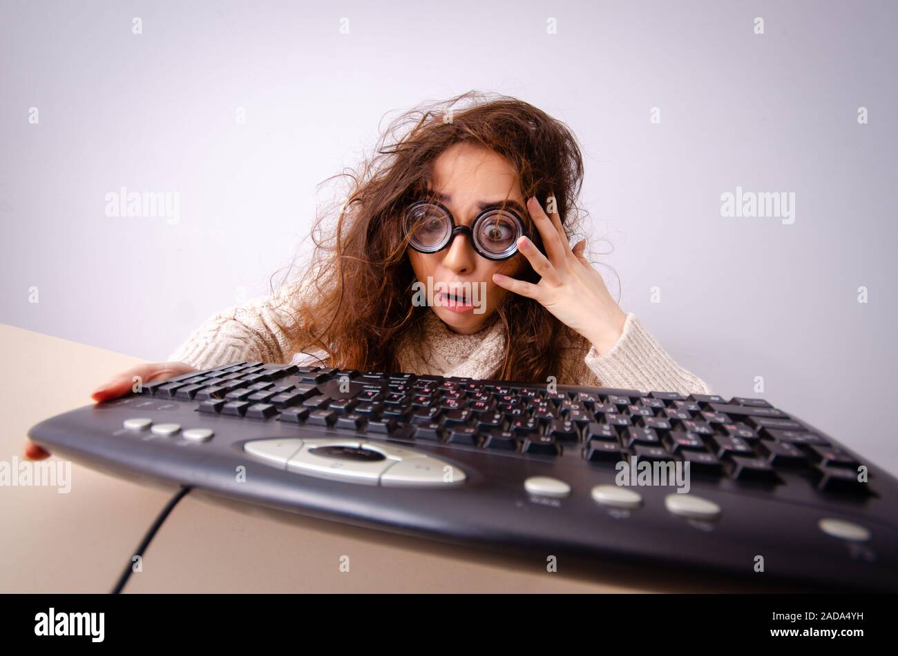 Funny nerd girl working on computer Stock Photo - Alamy