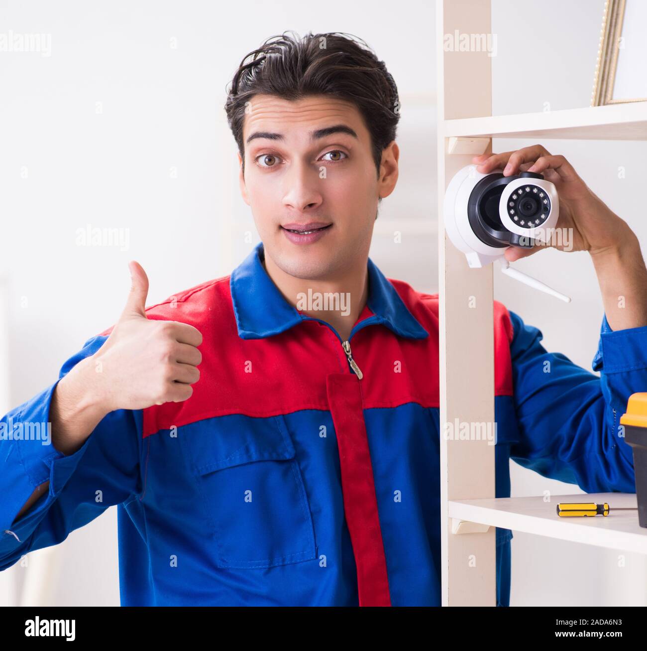 Client getting securty camera installed at home by contractor Stock Photo
