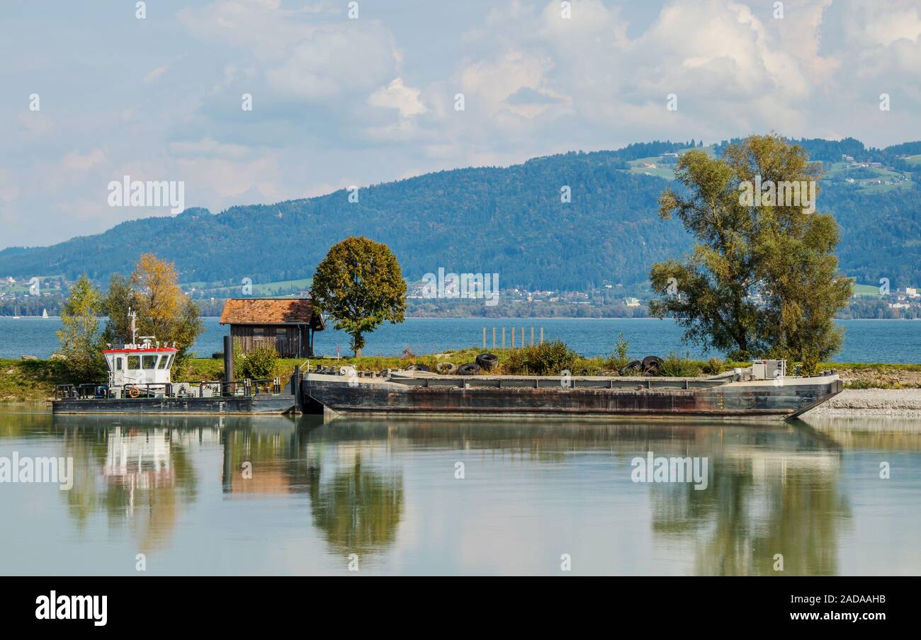 Excavator and gravel barges on the new Rhine near Fussach, Austria Stock Photo