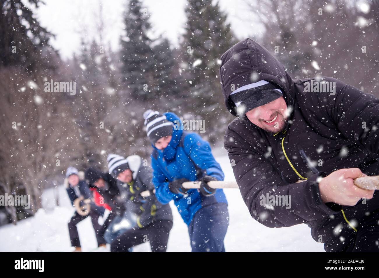 group of young people pulling a rope in tug of war competition Stock ...
