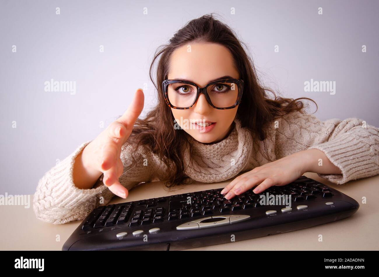 Funny nerd girl working on computer Stock Photo
