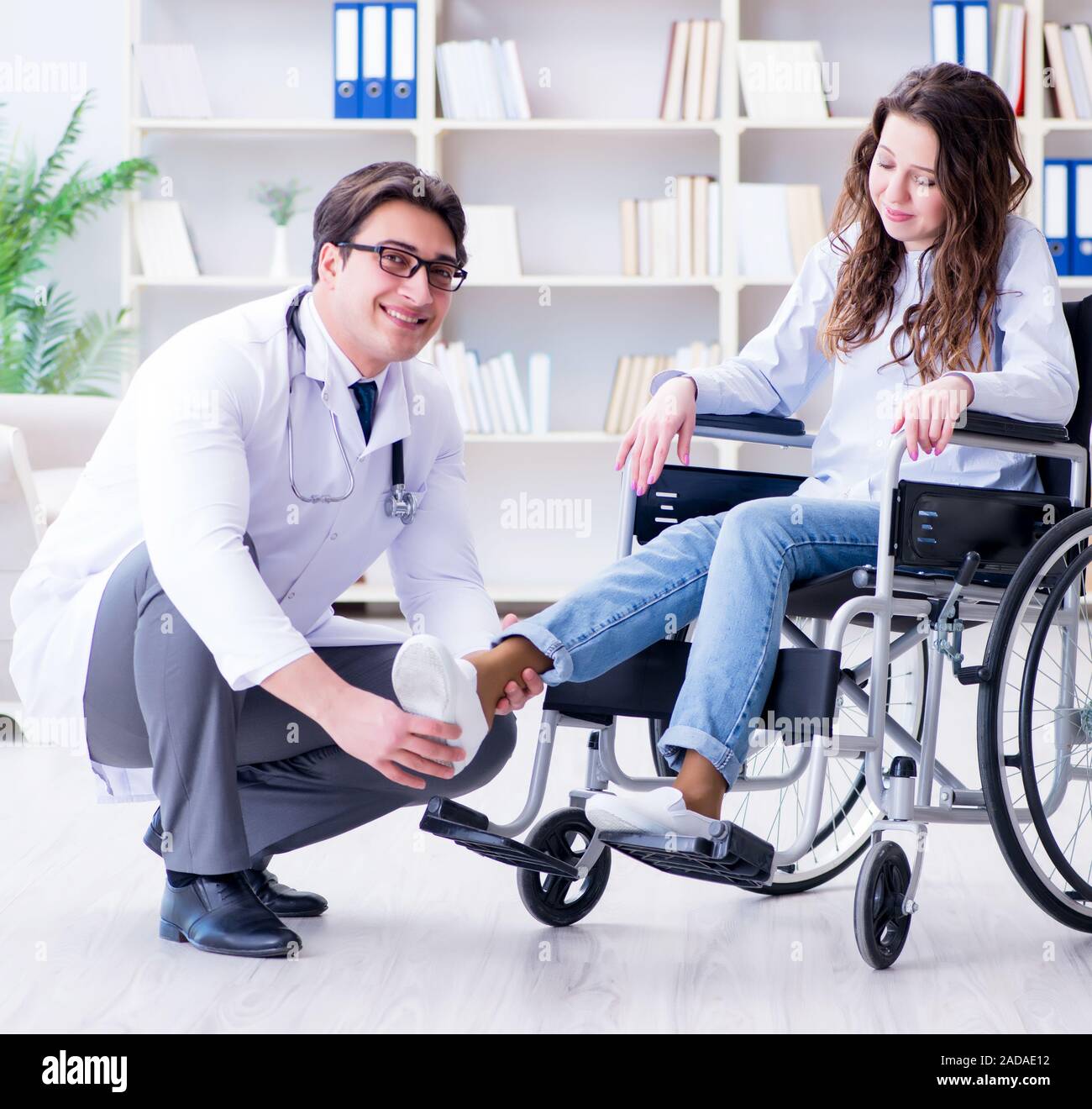Disabled patient on wheelchair visiting doctor for regular check Stock