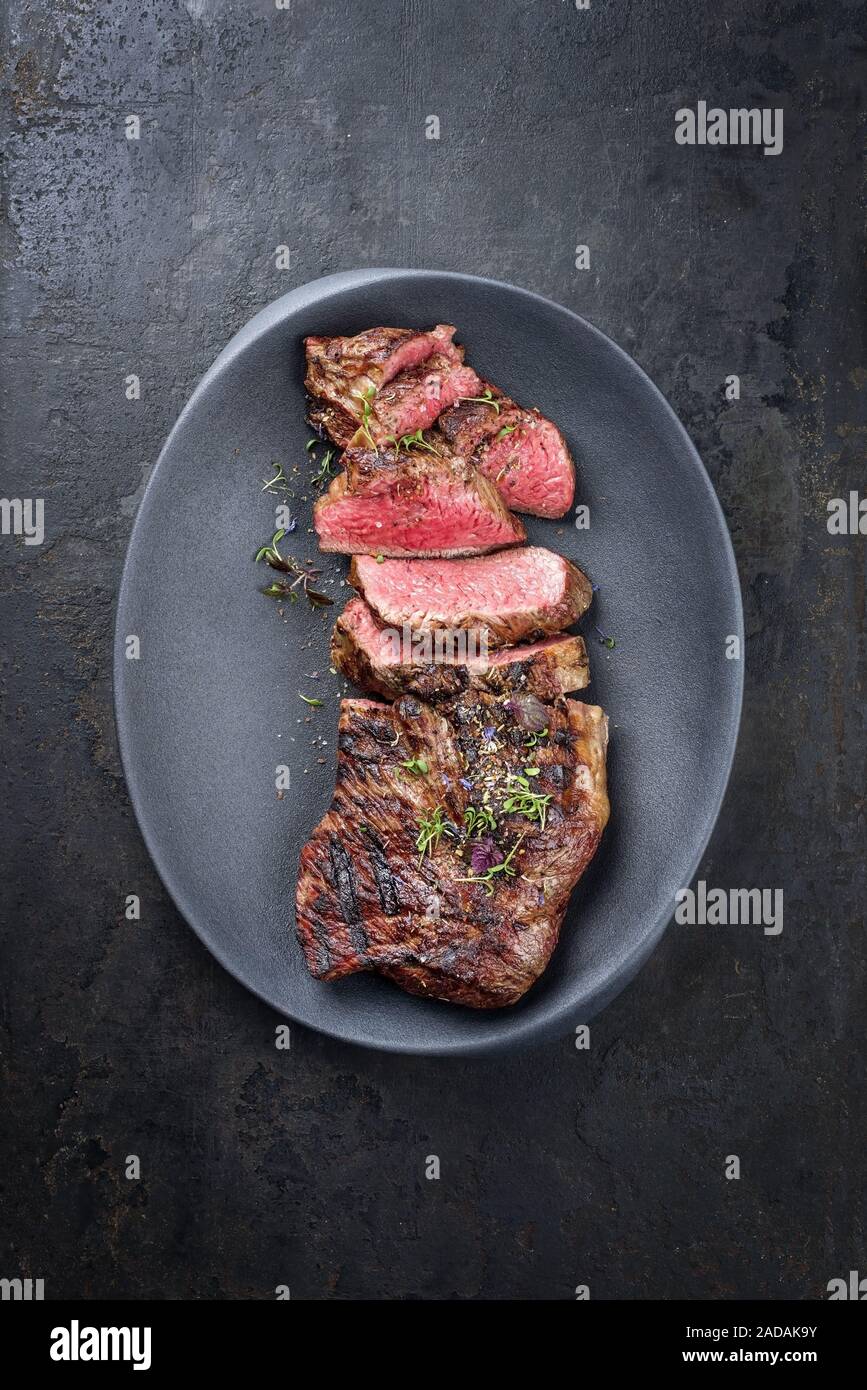 Barbecue dry aged wagyu tri tip steak sliced as top view in a modern