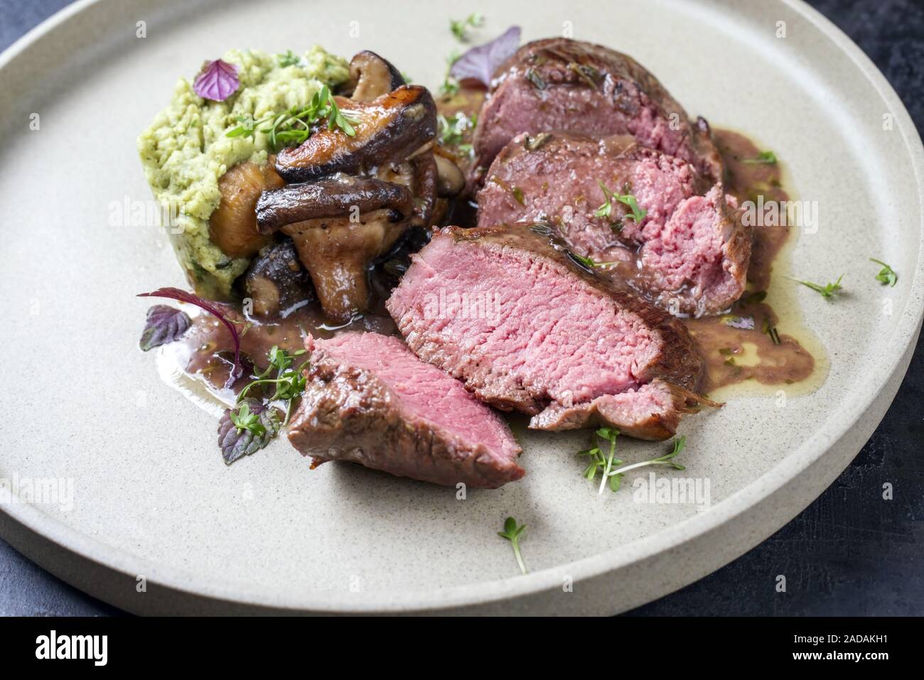 Barbecue aged sliced venison sirloin with mushroom in gammon red wine