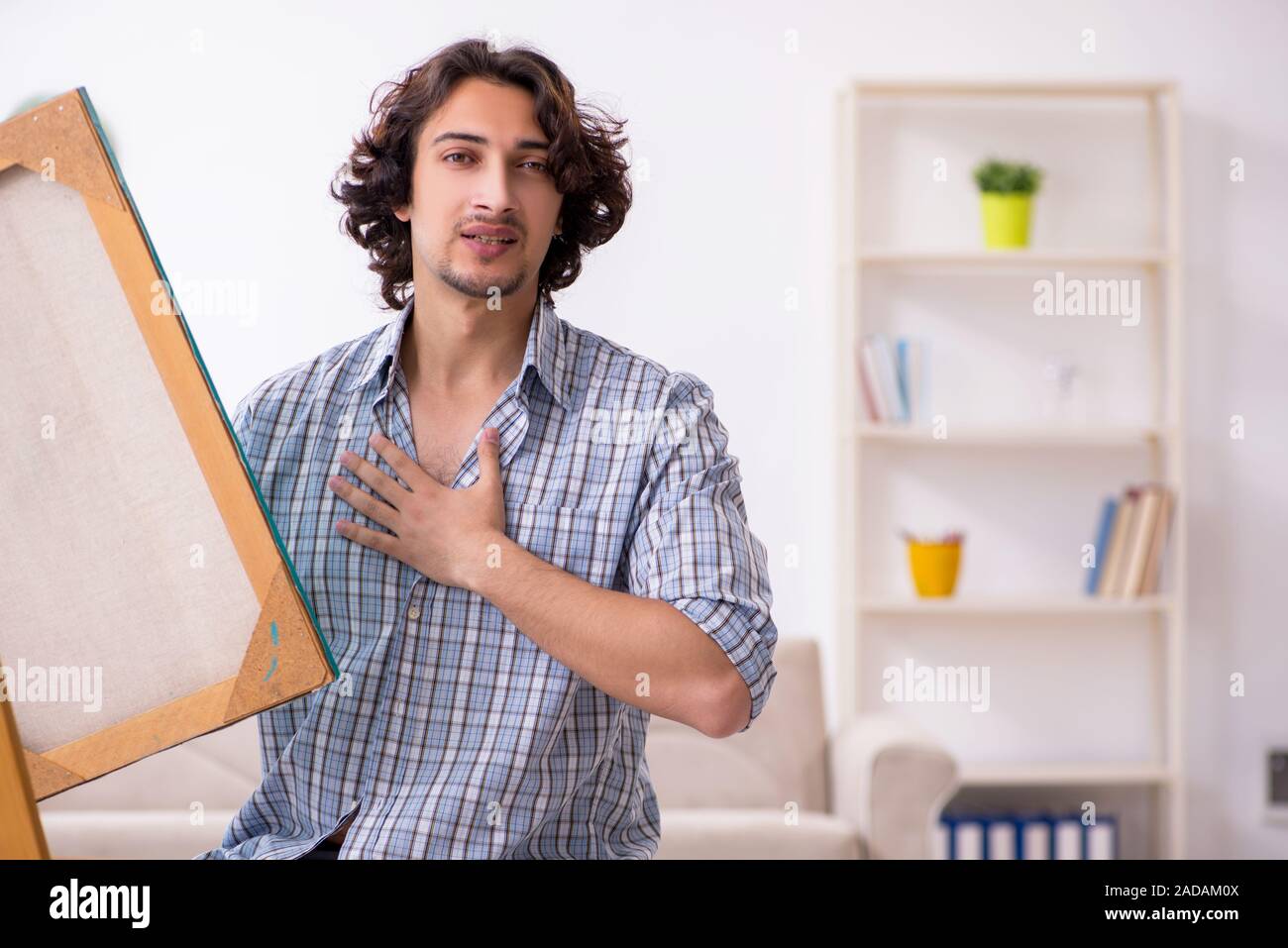 Young handsome man enjoying painting at home Stock Photo - Alamy