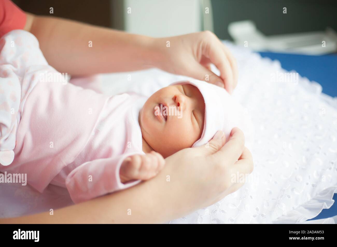 close up. mom correcting the cap, her newborn baby. the concept of motherhood Stock Photo