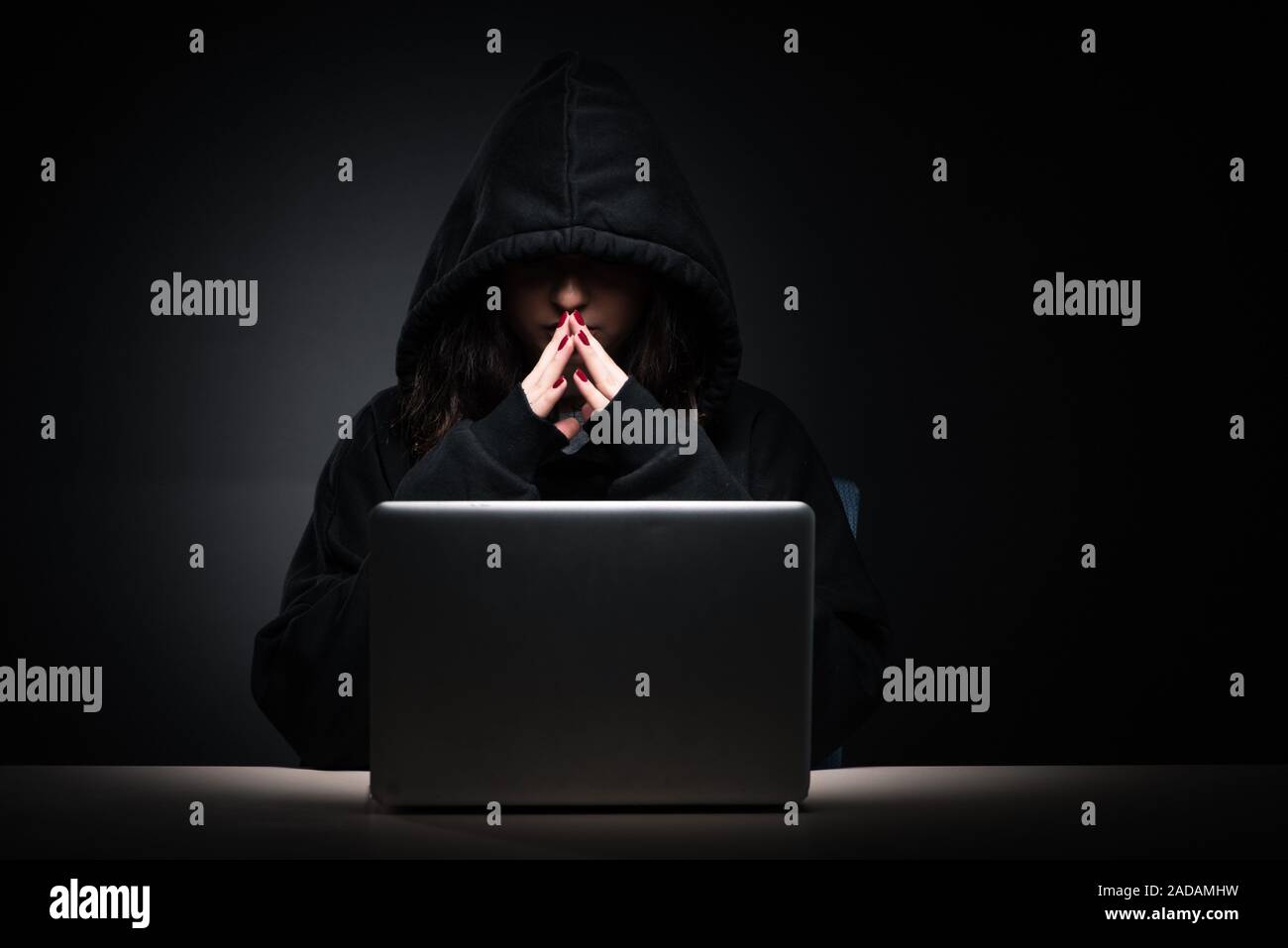 Female hacker hacking security firewall late in office Stock Photo