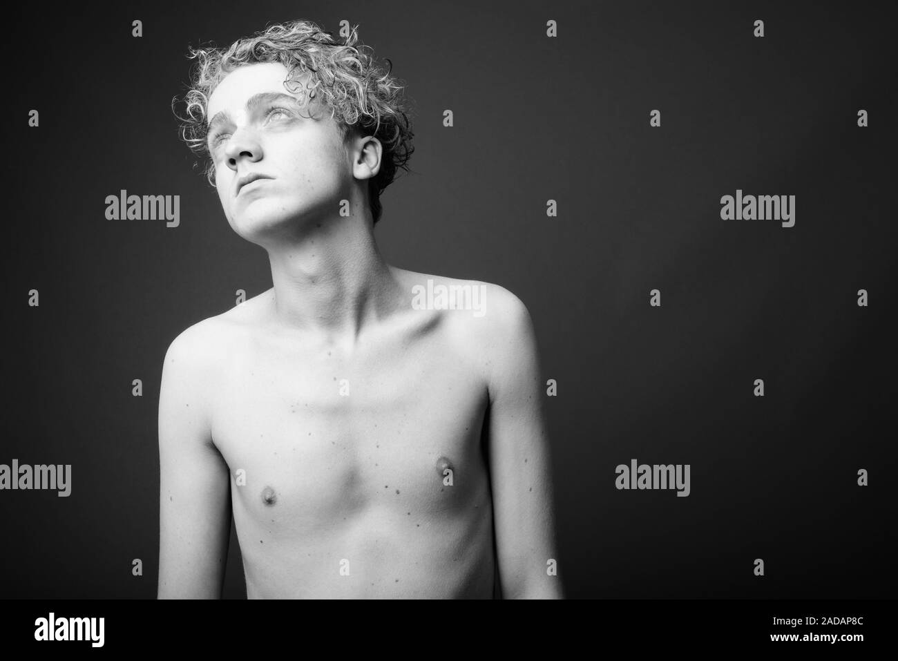 Skinny Young Man With Curly Hair Shirtless In Black And White