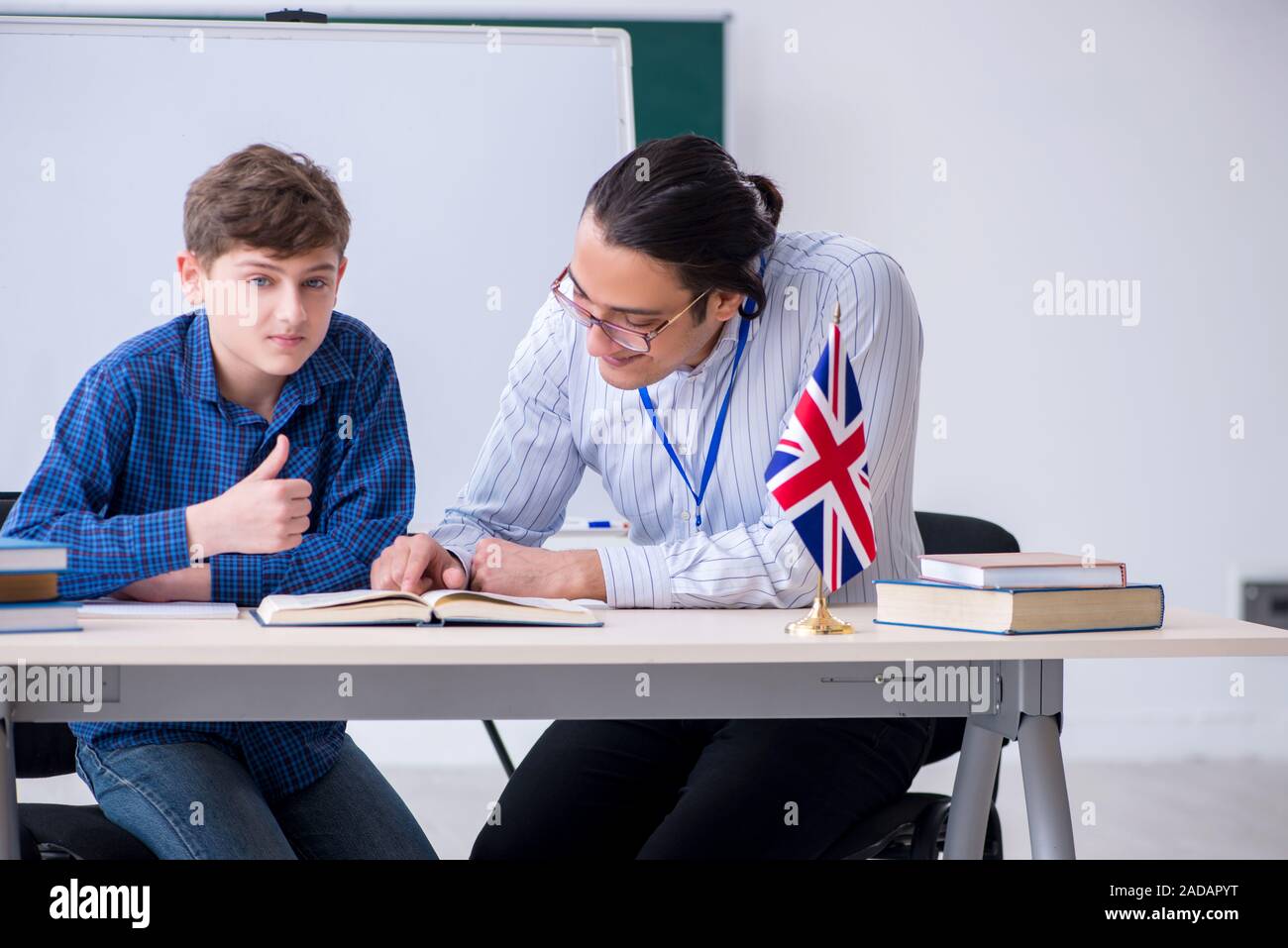 Male english teacher and boy in the classroom Stock Photo