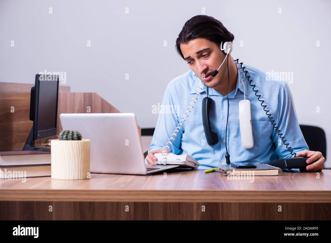 Call center operator working at his desk Stock Photo - Alamy