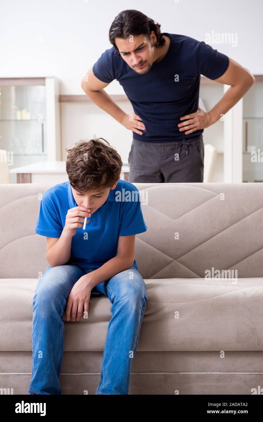 Concept of underage smoking with young boy and family Stock Photo