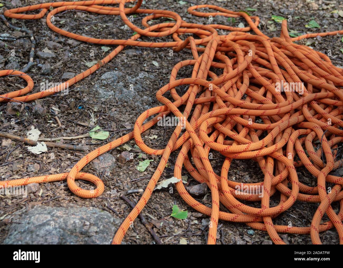 Climbing rope on ground among stones Stock Photo - Alamy