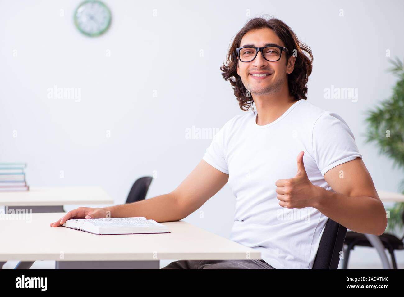 Young male student sitting in the classroom Stock Photo - Alamy