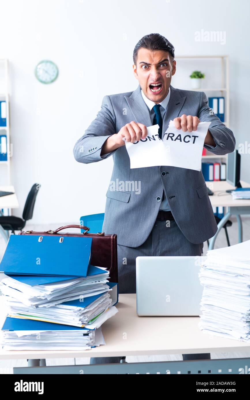 Businessman with heavy paperwork workload Stock Photo