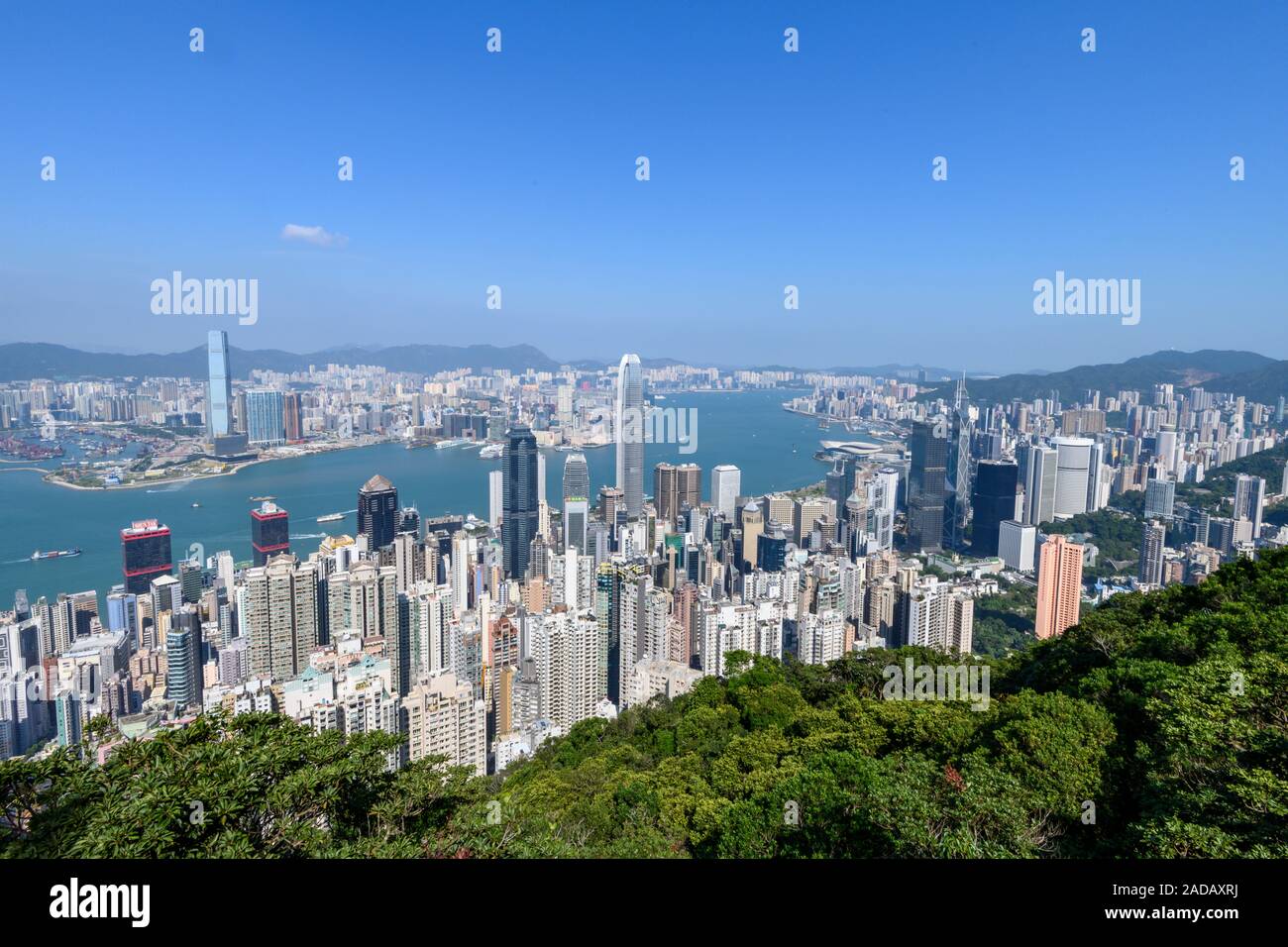 Hong Kong skyline and Victoria Harbour as seen from the Peak during the day. Stock Photo