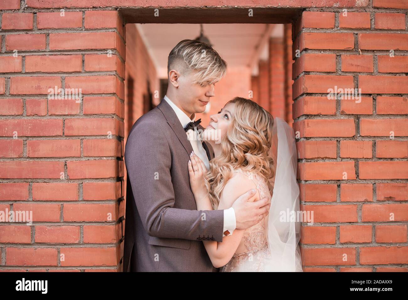 happy newlywed couple hugging each other while walking . holidays and ...