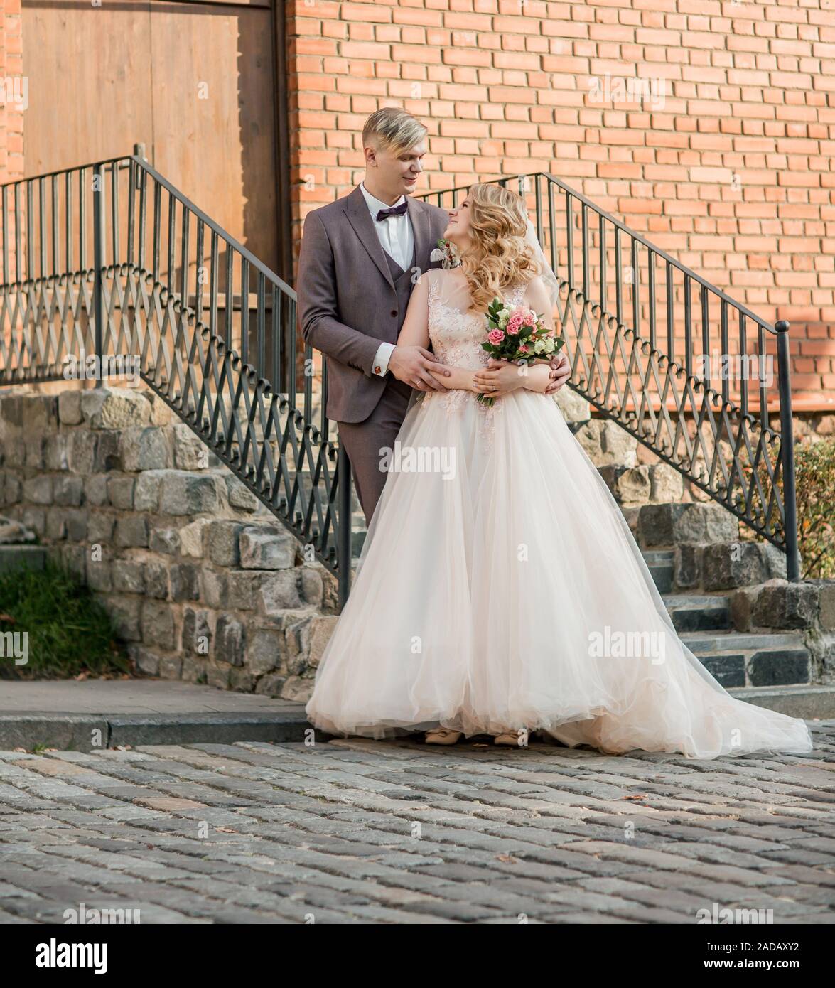 bride and groom kiss, standing on the porch of the house. holidays and ...