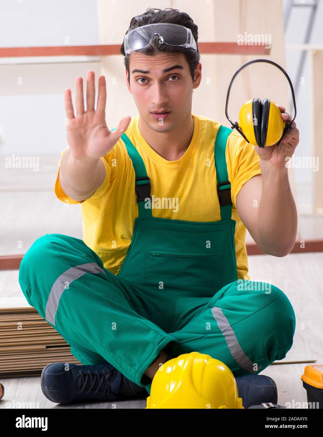 Worker showing the importnace of wearing noise cancelling headph Stock