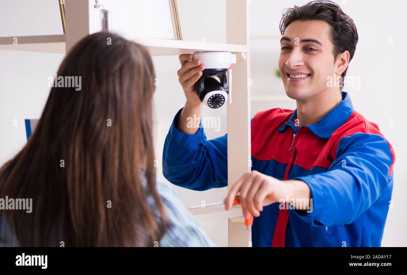 Client getting securty camera installed at home by contractor Stock Photo