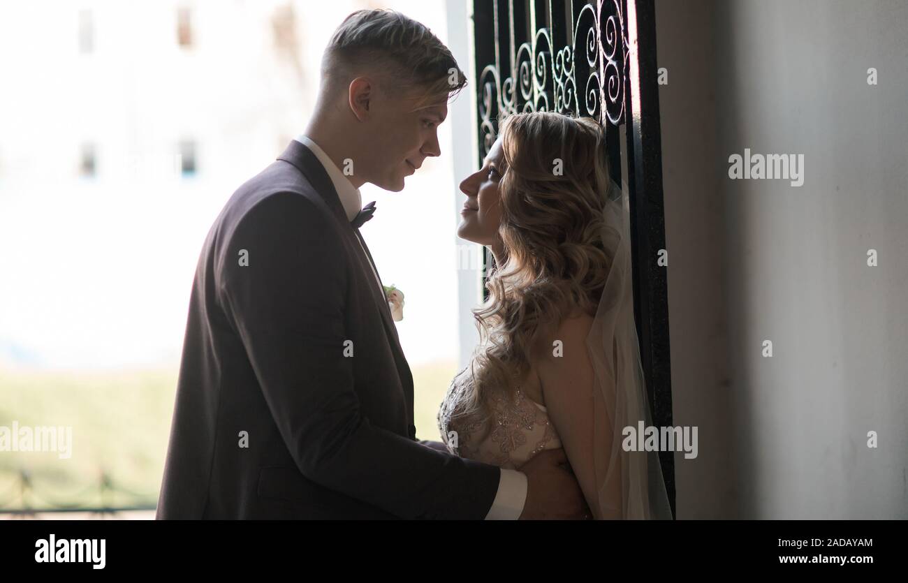 bride and groom talking standing near the door. holidays and events ...