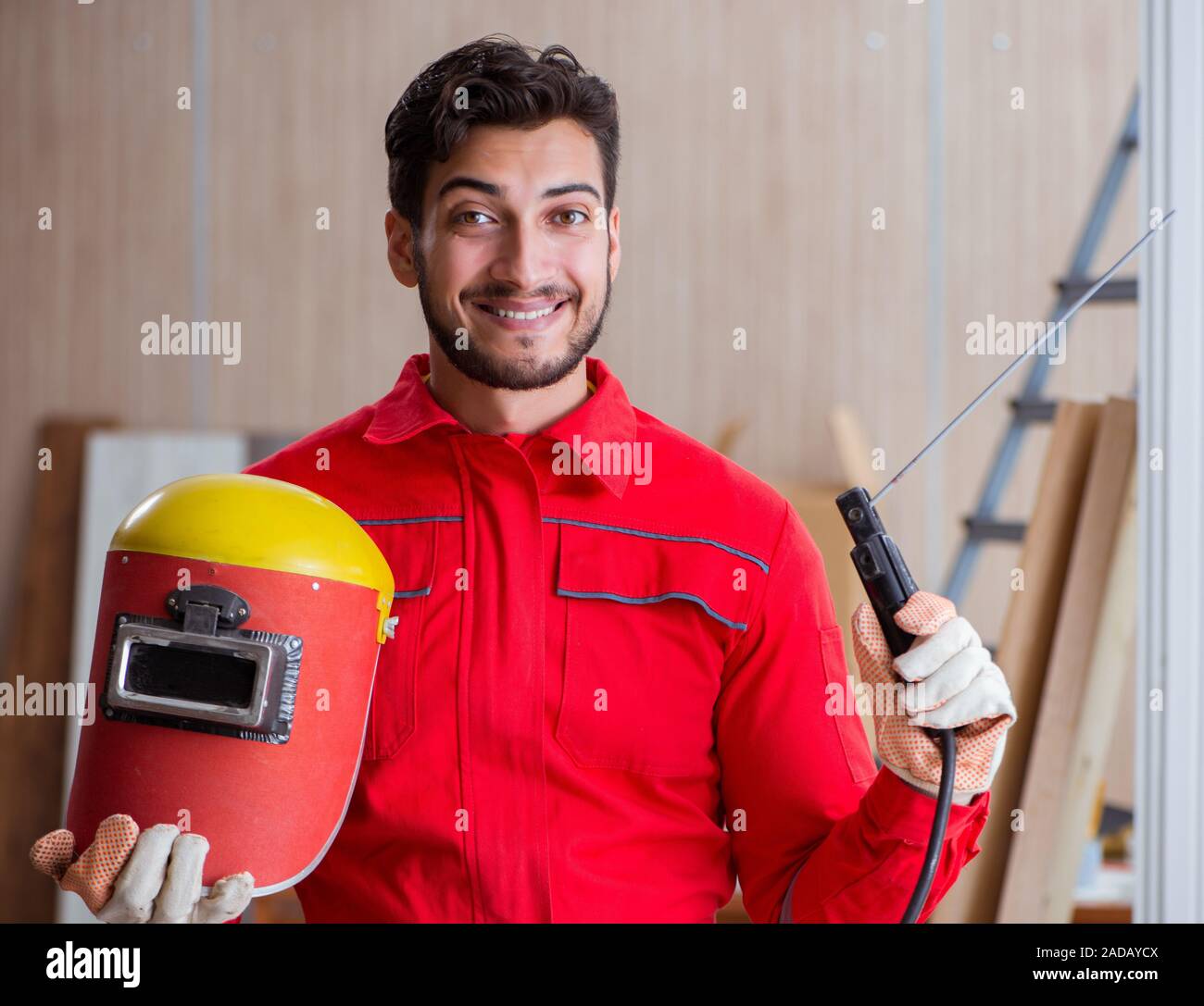 Young repairman with a welding gun electrode and a hi-res stock
