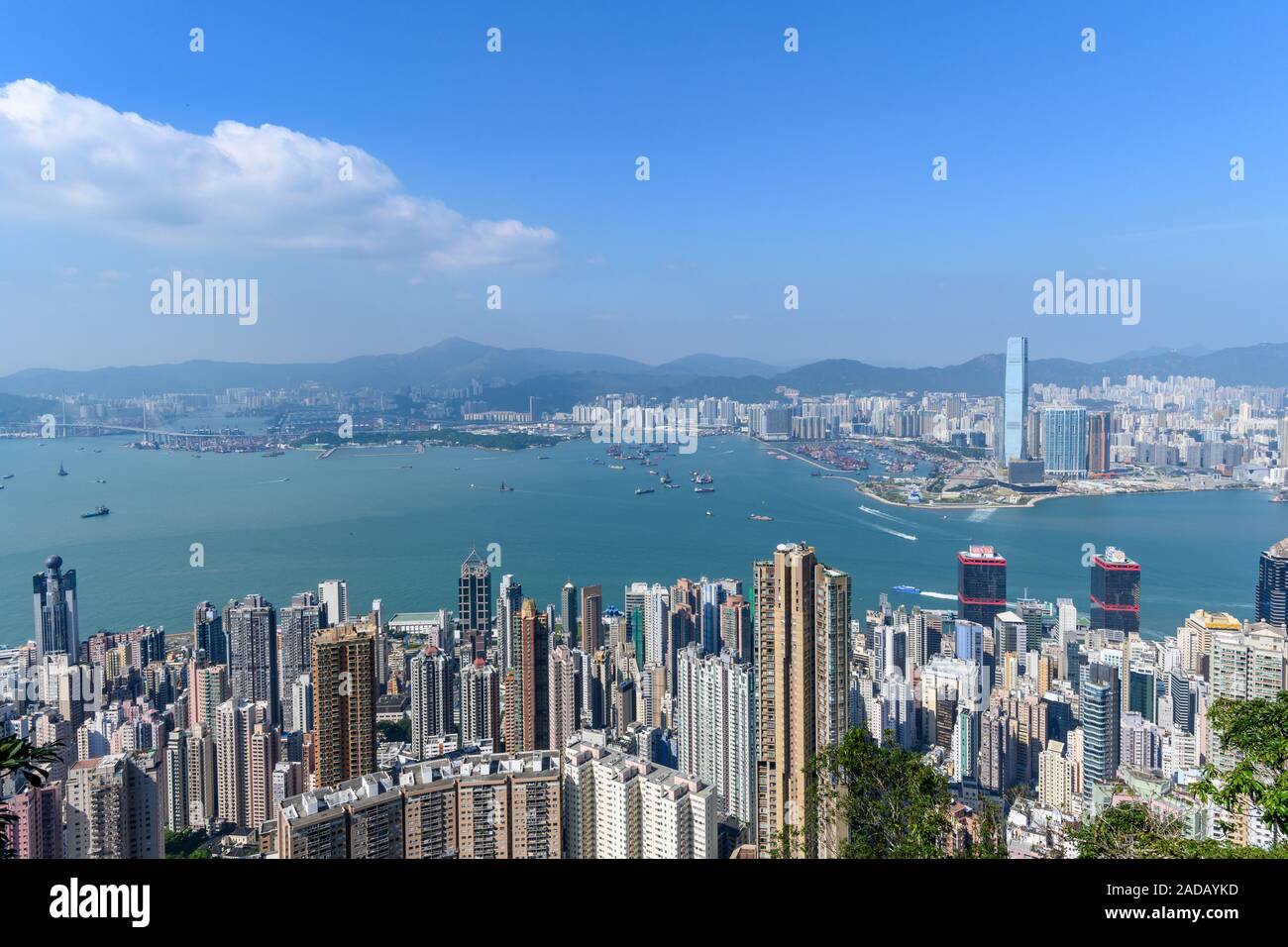 Hong Kong skyline and Victoria Harbour as seen from the Peak during the day. Stock Photo
