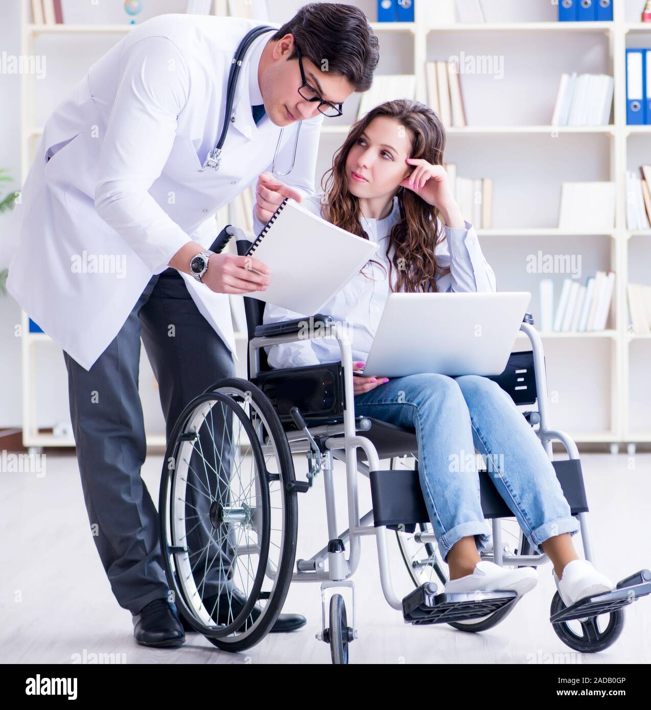 Disabled patient on wheelchair visiting doctor for regular check Stock