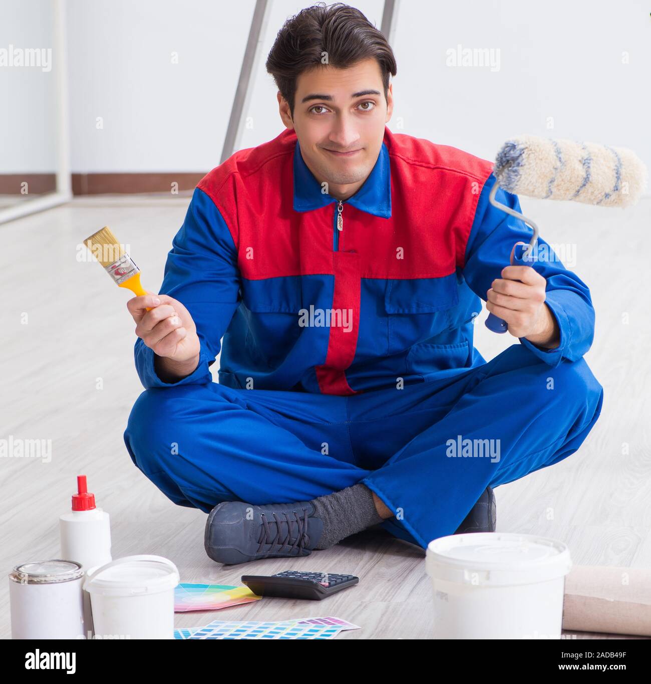 Young painter trying to match colours for painting job Stock Photo Alamy