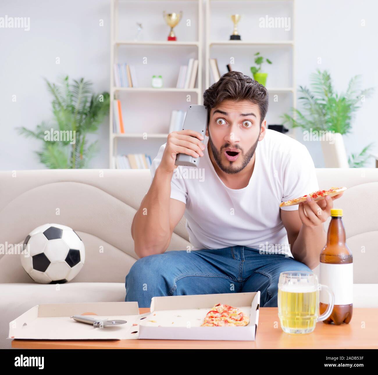 Man eating pizza having a takeaway at home relaxing resting Stock Photo Alamy