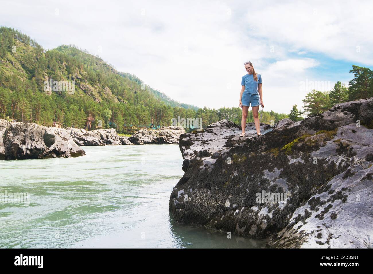 Woman resting at river Stock Photo - Alamy