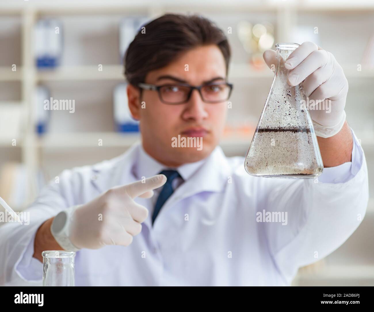 Young researcher scientist doing a water test contamination expe Stock