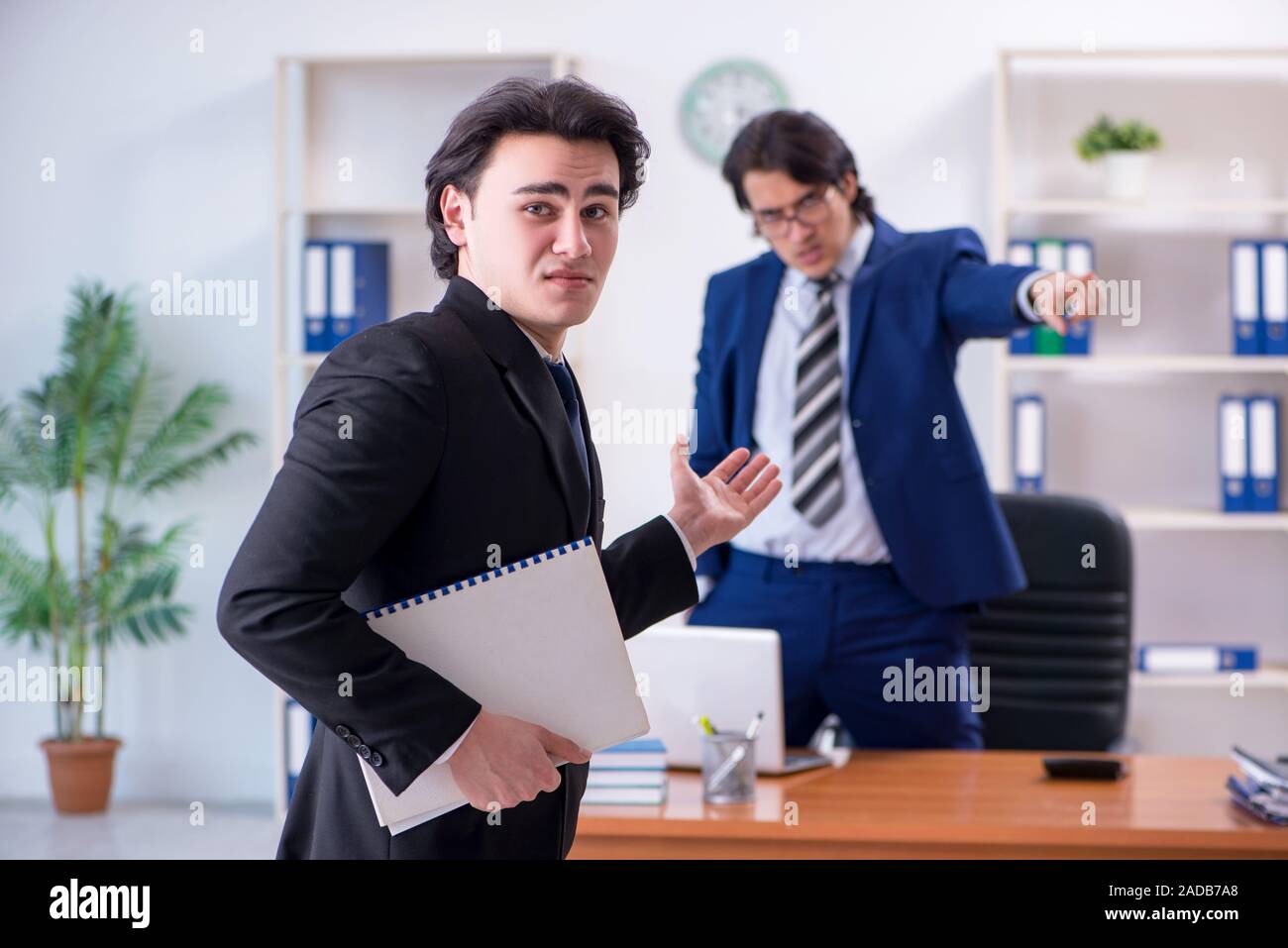 Boss and his male assistant working in the office Stock Photo - Alamy