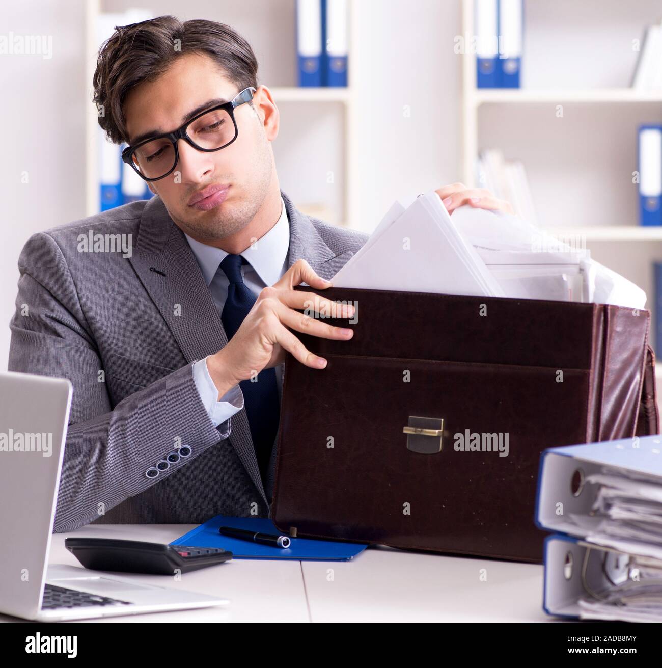 Employee with too much work taking it home Stock Photo - Alamy