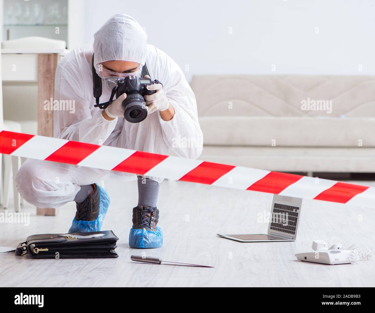 Forensic expert at crime scene doing investigation Stock Photo
