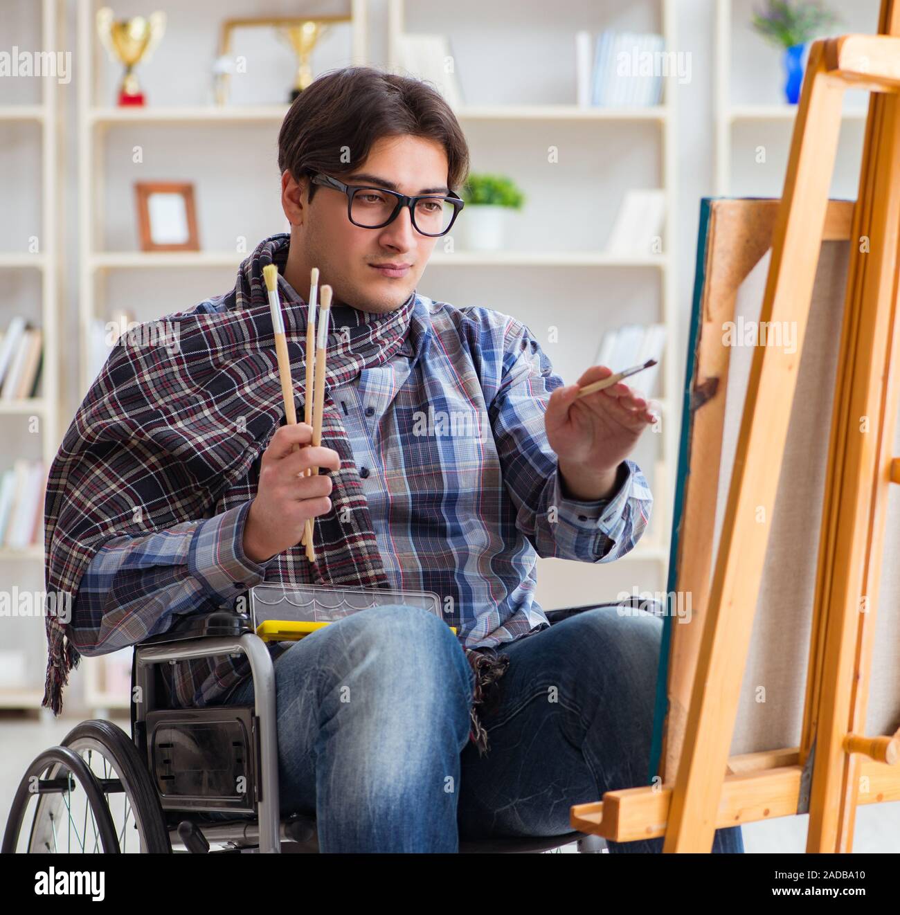 Disabled artist painting picture in studio Stock Photo