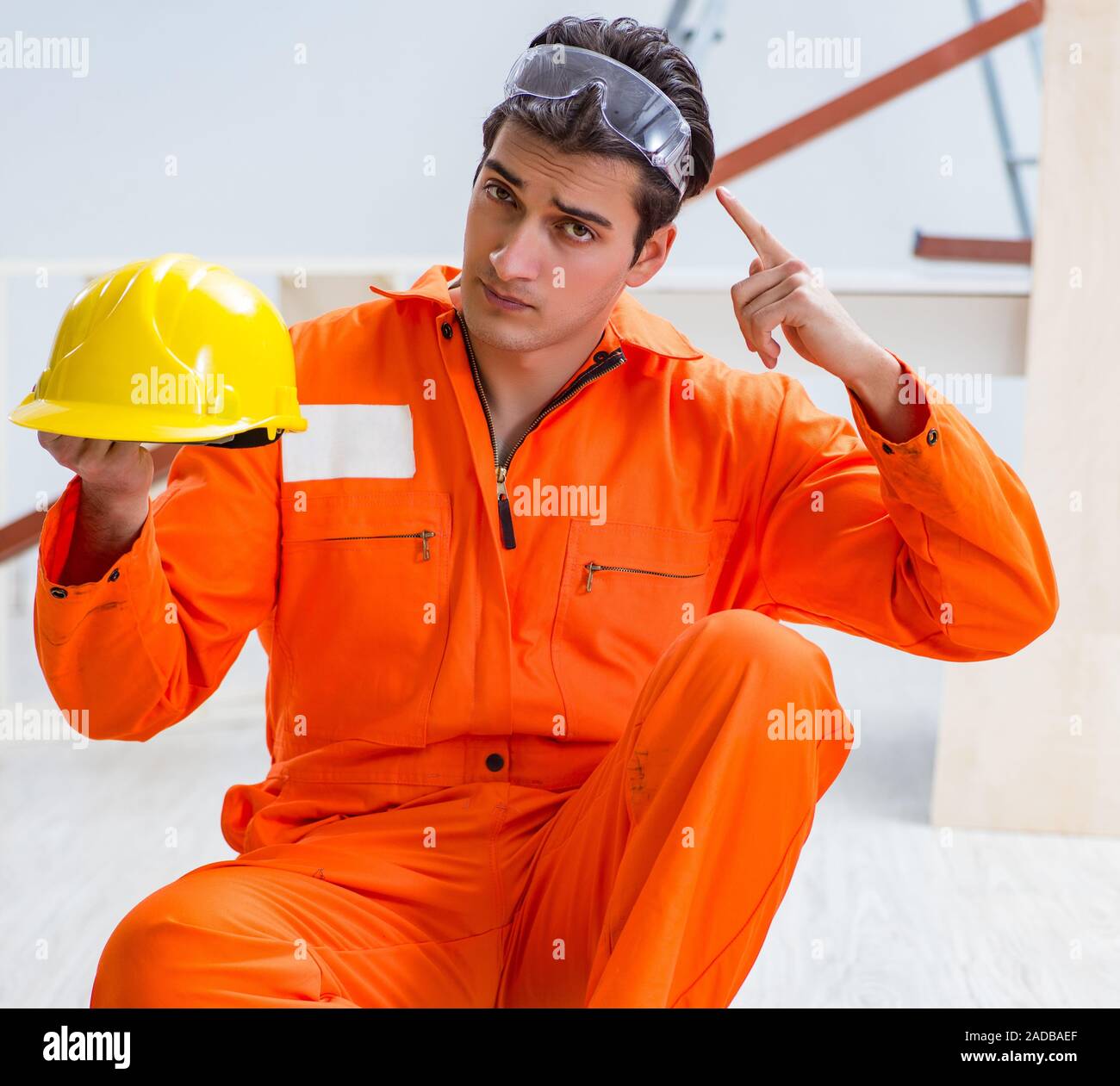 Contractor Yellow Mechanic wearing yellow construction helmet hi-res stock photography ...