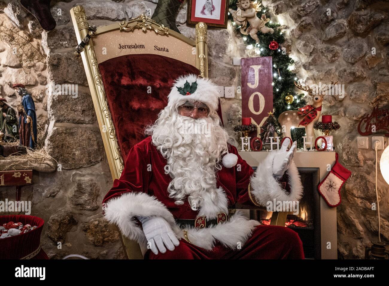 Jerusalem, Israel. 02nd Dec, 2019. Issa Kassissieh disguised as Santa Claus sits in his house on a golden throne. The former basketball player refers to several diplomas and certificates from Santa Claus schools in the USA and the Santa Claus World Congress in Copenhagen and is considered the only professional Santa Claus in the Middle East. (to dpa 'Santa Claus graduated from Jerusalem') Credit: Ilia Yefimovich/dpa/Alamy Live News Stock Photo