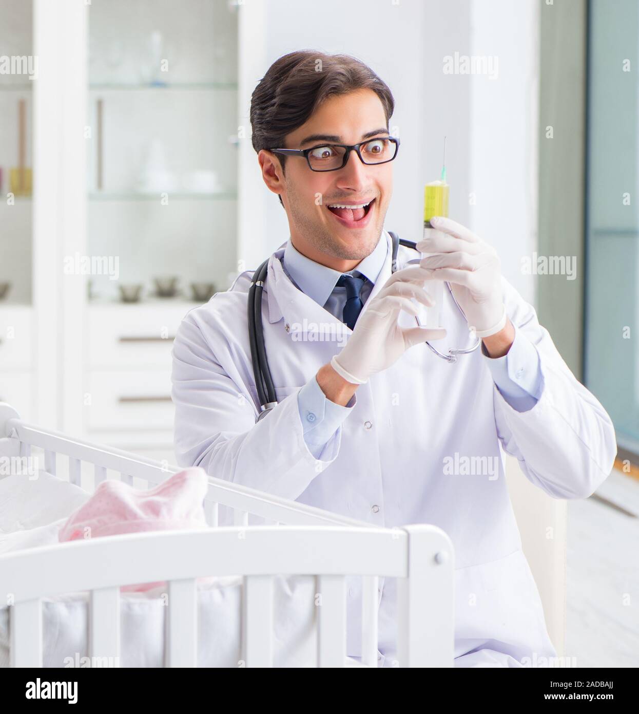 Doctor examining baby on bed hi-res stock photography and images - Alamy